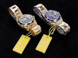 three different watches with tags attached to them on a black surface