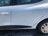 a silver car parked in a parking lot next to a building