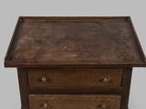 an old wooden table with three drawers and a drawer underneath it
