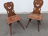 pair of antique wooden chairs with hearts on the backs