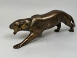 bronze figurine of a lion on a white background