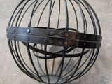 a metal ball that has a leather strap around it