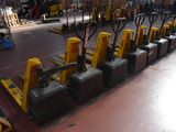many forklifts lined up in a large warehouse