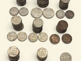 a lot of coins that are on a white surface