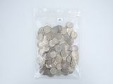 a bag full of silver coins on a white surface