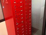many red lockers in the corner of a room