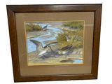 painting of two birds flying over a body of water in a wooden frame