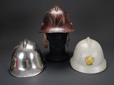 two helmets and a helmet on a mannequin head on a table