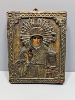 un gros plan d'une plaque métallique sur laquelle figure une image religieuse