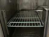 a man standing inside of an oven with a rack in it