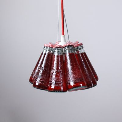 a red and white hanging light with a red cord