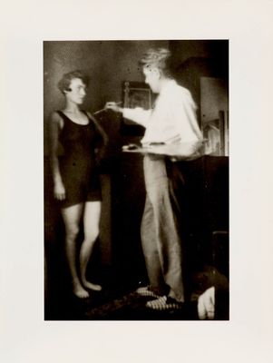 a black and white photo of a man standing next to a woman