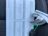 a car seat with a bunch of papers attached to the back of it