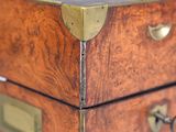 a close up view of a wooden chest of drawers