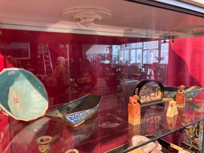 a glass display case with a lot of decorative items in it