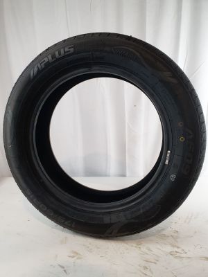 an image of a tire on a white surface with a curtain in the background