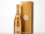 a bottle of champagne in front of a gold box