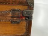 a wooden trunk with metal latches on it