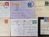 many old envelopes on a table with a tablet