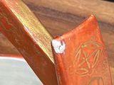someone is using a knife to cut a piece of wood with a sharp knife