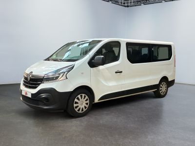 the white van is parked in a large room with a black floor