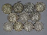six different types of coins are arranged on a table