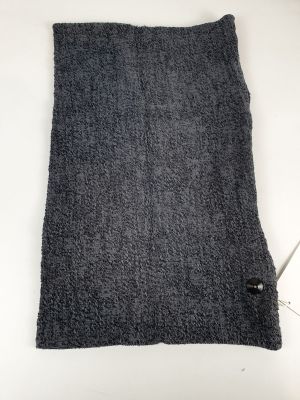 a gray towel sitting on top of a white table