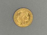 a close up of a gold coin on a gray surface