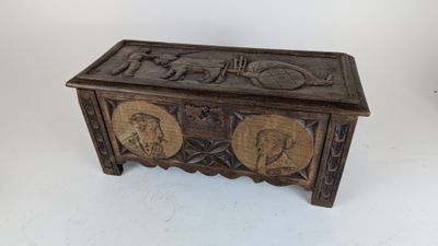 an old wooden chest with carvings on the sides of it