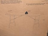 cardboard box on the ground with a drawing of a table on it