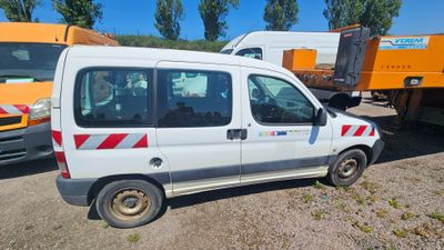 a white van that is parked in the dirt