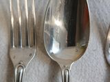 une cuillère, une fourchette et un repose-cuillère posés sur une table