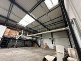 a large room with a lot of windows and a ceiling fan