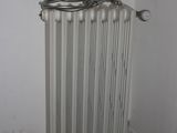 a radiator in the corner of a room with a sign on the wall