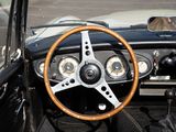 a steering wheel and dashboard of a car in a parking lot