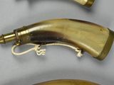 three horn shaped items are displayed on a table