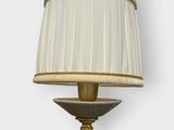 a close up of a lamp with a white shade on it