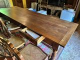 a table that has a bunch of chairs around it