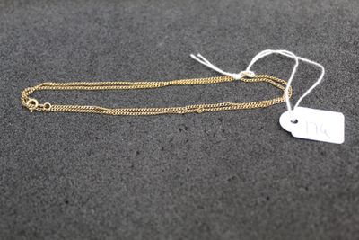 a close up of a gold chain with a tag attached to it