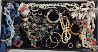 a black box filled with lots of jewelry on a table