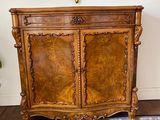 a wooden cabinet with a clock on top of it
