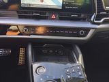 the interior of a car with a touch screen and steering controls