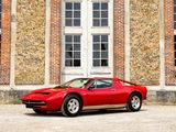 a red sports car parked in front of a brick building