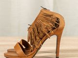 a close up of a pair of shoes with fringes on them