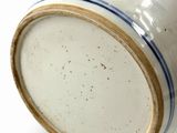 a close up of a white and blue vase