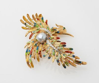 a gold brooch with a pearl in the center