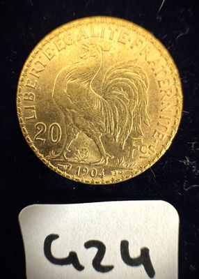 l'image d'une pièce d'or posée sur une surface noire, accompagnée d'une étiquette blanche