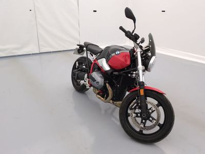 a red and black motorcycle parked in a white room
