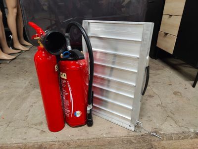 a fire extinguisor next to a heater on the floor