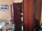 a black chair in a room with a wooden door
